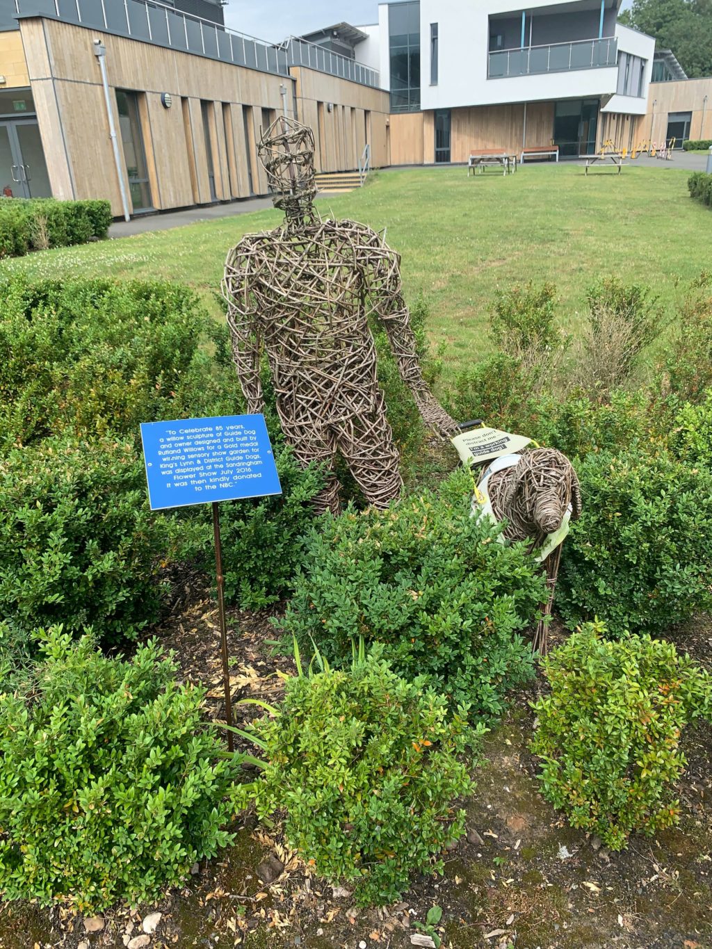 Willow sculpture of a guide dog and their owner at The Guide Dogs UK National Breeding Centre in Warwickshire